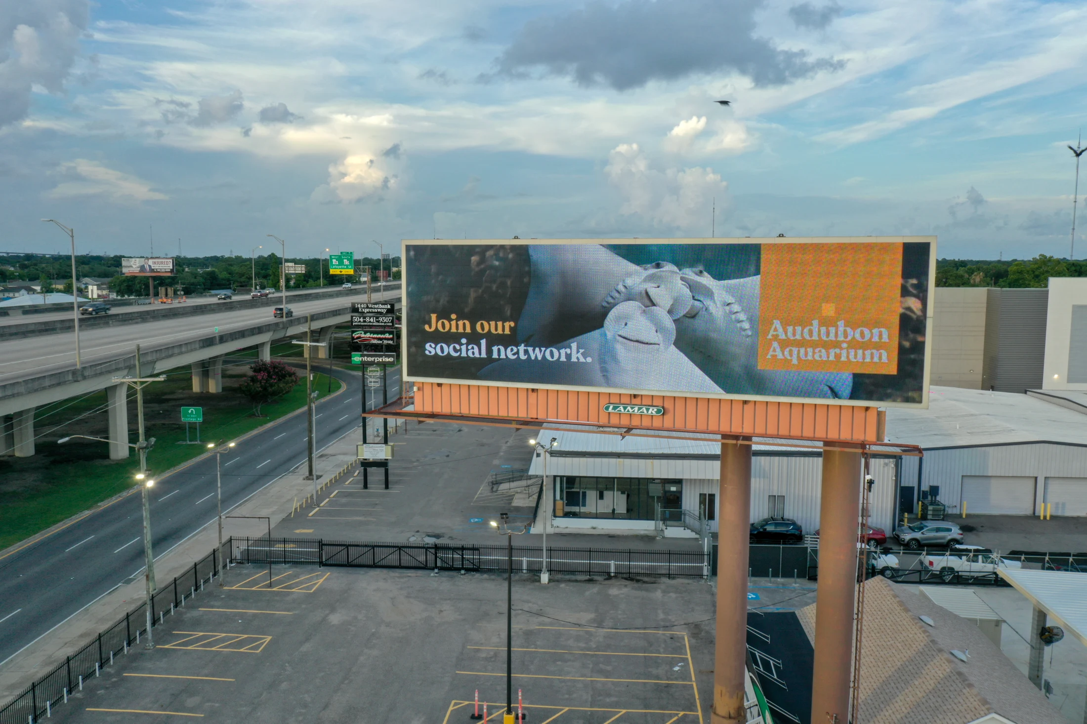 Audubon Aquarium digital billboard beside an elevated roadway