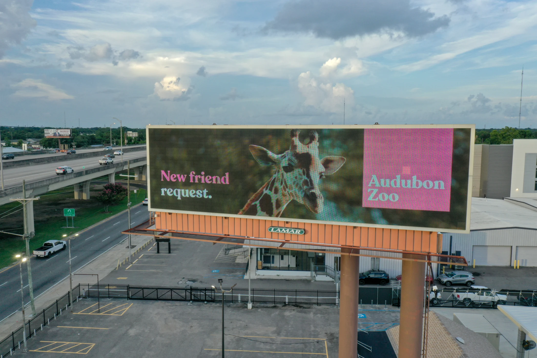 Audubon Zoo digital billboard featuring a giraffe and the message New friend request