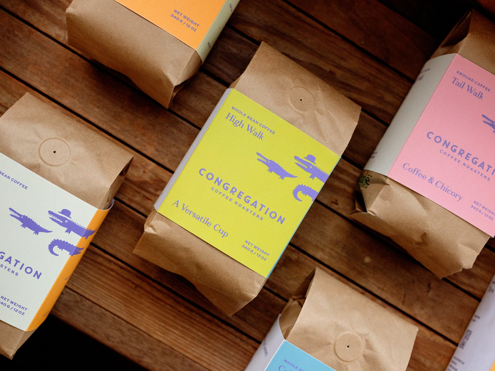 Congregation Coffee bags with colorful illustrated labels arranged on a wooden table