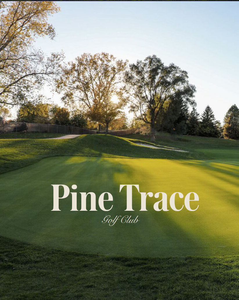 Pine Trace Golf Club wordmark over a sunlit putting green bordered by trees