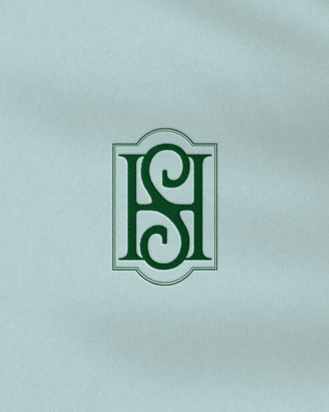 Shepherd’s Hollow green monogram on pale textured paper