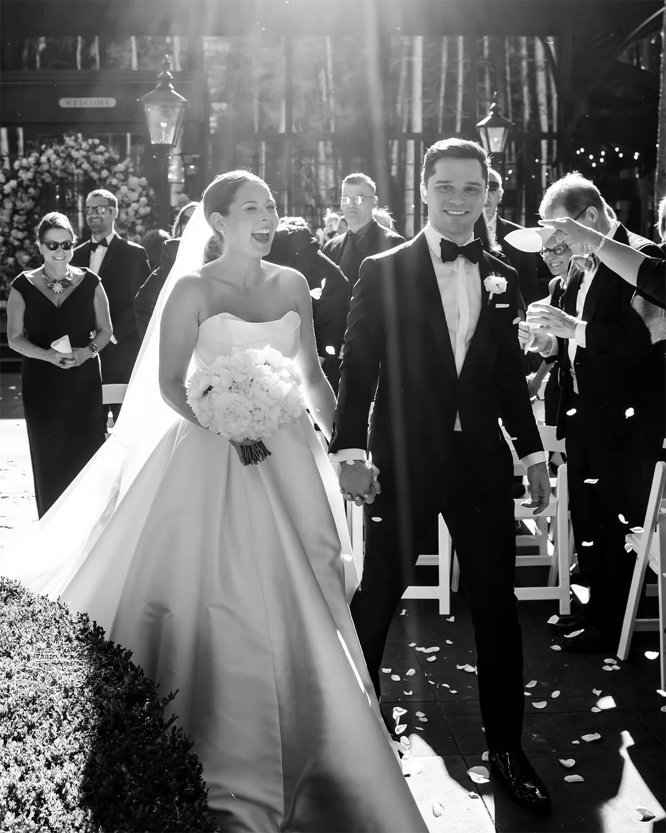 A couple exits their wedding celebration at The Station beneath falling confetti