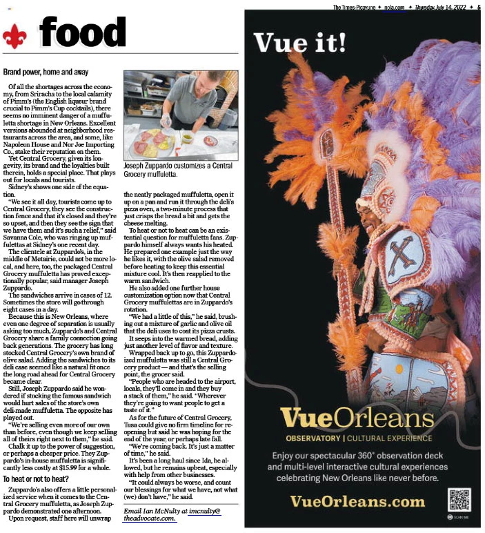 Printed magazine page with a Vue Orleans advertisement featuring a feathered costume