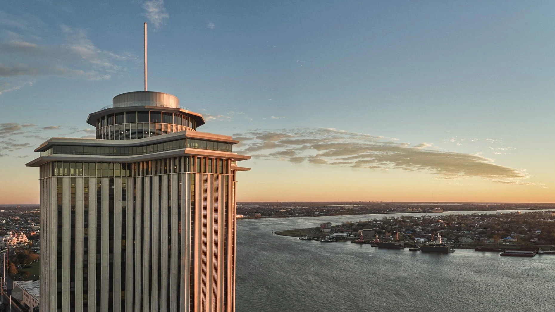 Vue Orleans observation deck overlooking the Mississippi River at sunset